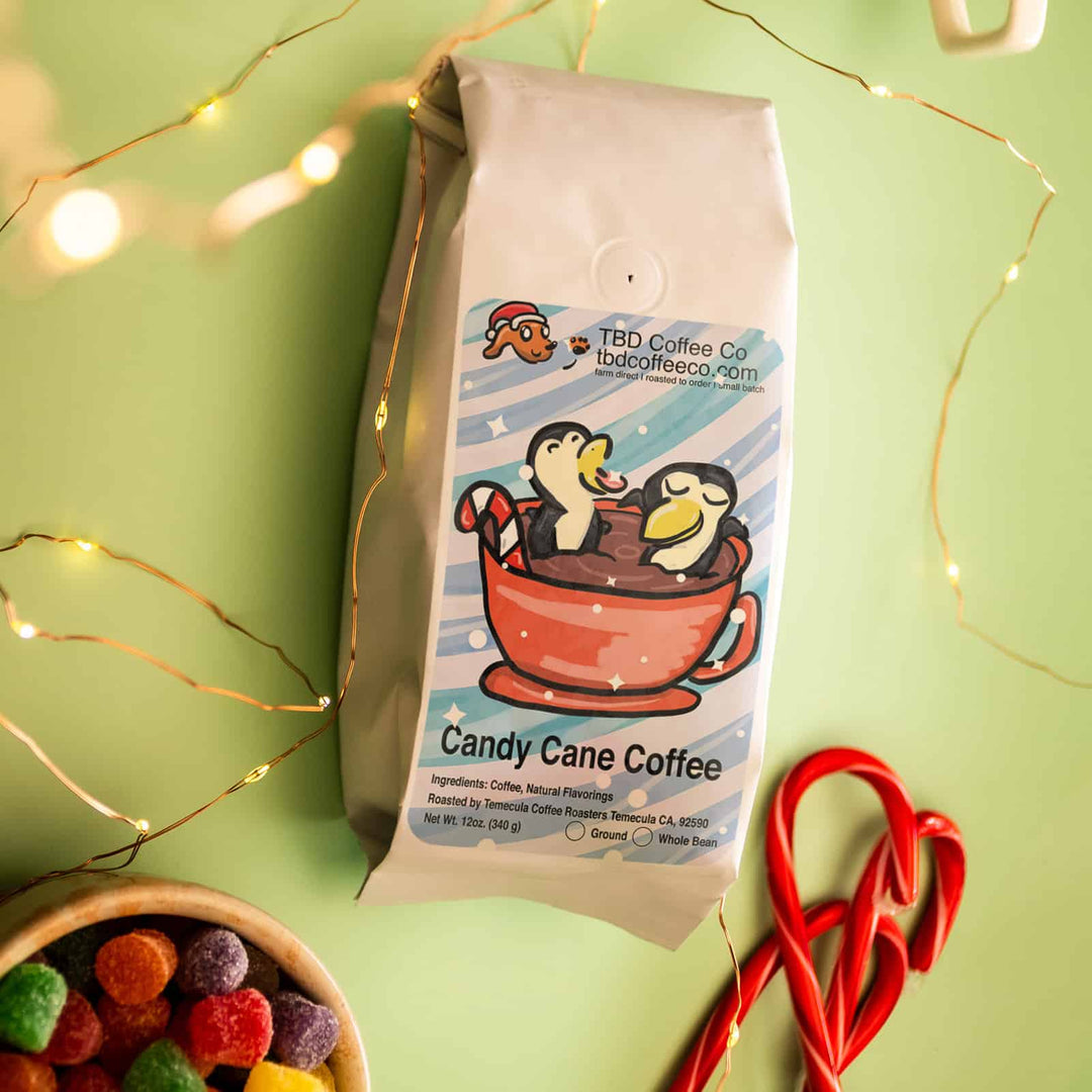 TBD Coffee Co Candy Cane Coffee with 2 penguins in a coffee mug